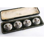 AN EDWARDIAN CASED SET OF FOUR DOMED CIRCULAR MENU CARD HOLDERS, each in the form of an owl mask