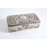 A LATE VICTORIAN EMBOSSED JEWELLERY BOX of rounded oblong form with a central cartouche, initialled,