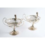 A PAIR OF PEDESTAL BONBON DISHES with pierced bowls and three loop handles, by Joseph Rogers,