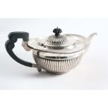 A LATE VICTORIAN CIRCULAR TEA POT with part-fluted decoration and a "cape" rim, by Elkington Co.
