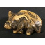 JAPANESE IVORY NETSUKE OF A BUFFALO, recumbent facing to the left, 4cm