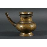 INDIAN OR NEPALESE BRONZE POURING VESSEL, the ovoid body with ring neck and long spout on a