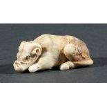 THREE JAPANESE NETSUKE, the first modelled as a recumbent cow, height 5.5cm, together with a