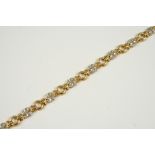 A DIAMOND AND 18CT. GOLD BRACELET formed as eight flowerheads, each set with four circular-cut