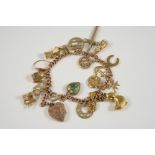 A 9CT. GOLD CHARM BRACELET the gold curb link bracelet is set with assorted gold charms, 34 grams.