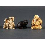 JAPANESE IVORY NETSUKE, carved as a figure seated on a rock with a three legged toad, signed,