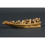 JAPANESE IVORY OKIMONO, Meiji, carved as seven figures in a boat, signed, length 16.5cm