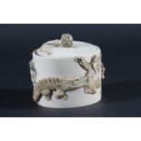 JAPANESE IVORY BOX AND COVER, carved with a monkey, crocodile, tiger and lion, the cover with a