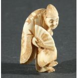 THREE JAPANESE NETSUKE, the first carved as a man standing on one foot holding a fan, height 4.