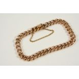 A 15CT. GOLD CURB LINK BRACELET with concealed clasp, 19cm. long, 13.4 grams.