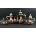 GRADUATED SET OF FOUR COPPER AND BRASS COFFEE POTS, probably Persian, with scrolling dragon