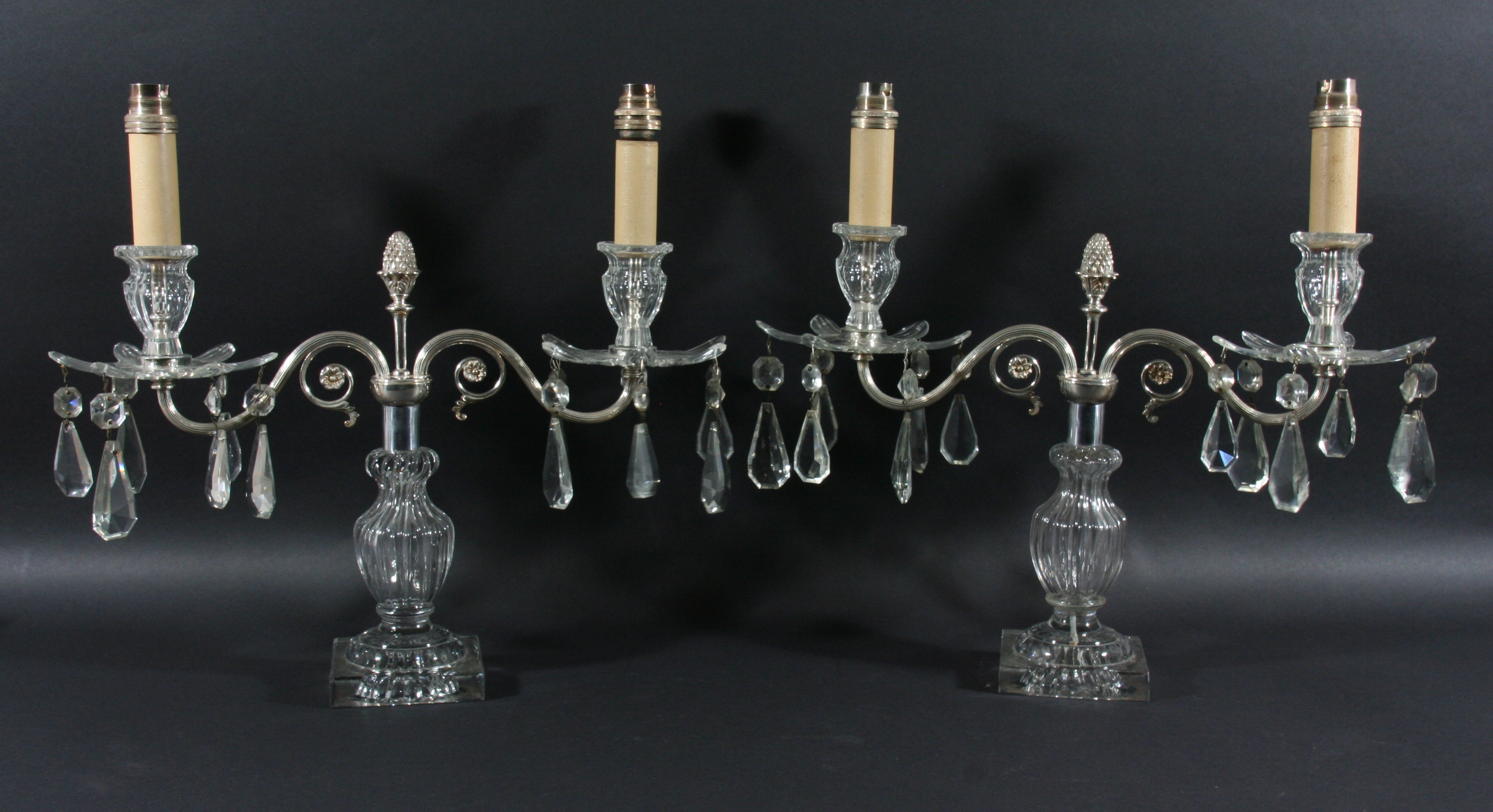 PAIR OF TWO LIGHT GLASS CANDELABRA the silver plated arms supporting floral drip trays, on reeded