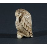 THREE JAPANESE NETSUKE, the first carved as a humorous bird of prey, height 4.5cm, together with a