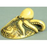 JAPANESE IVORY NETSUKE OF AN OCTOPUS ON A SHELL, Meiji, with tiger's eye eyes, unsigned, 6cm