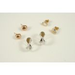 A PAIR OF 9CT. TWO COLOUR GOLD STUD EARRINGS together with two other pairs of gold stud earrings.