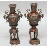 PAIR OF JAPANESE BRONZE VASES ON STANDS, Meiji, with bird and flower decoration in relief between