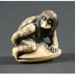 TWO JAPANESE NETSUKE, the first modelled as a figure half man and half turtle on a clam shell,
