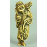 JAPANESE IVORY NETSUKE OF A MAN AND DRAGON, the man standing holding a staff and bowl with the
