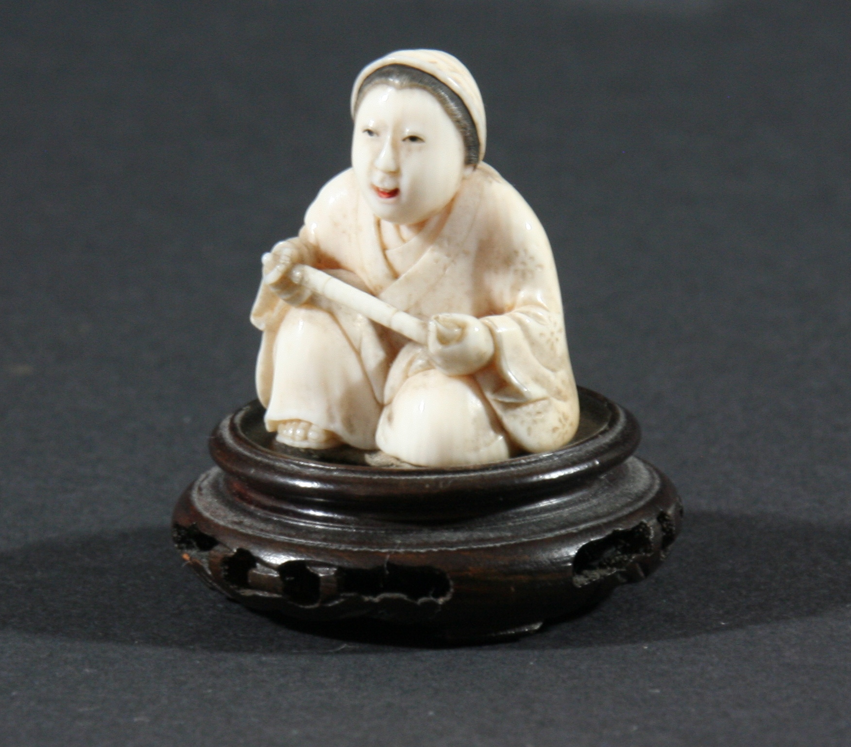 THREE JAPANESE NETSUKE, the first carved as a kneeling lady, height 3.5cm, together with a man