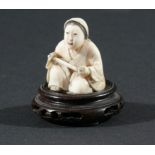 THREE JAPANESE NETSUKE, the first carved as a kneeling lady, height 3.5cm, together with a man