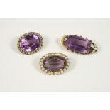 AN AMETHYST AND PEARL BROOCH the oval-shaped amethyst is set within a border of half pearls, in