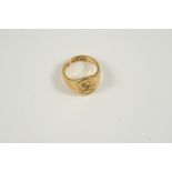 AN 18CT. GOLD SIGNET RING engraved with a crest, 16.3 grams. Size O 1/2.