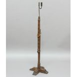 WROUGHT IRON ADJUSTABLE RUSH LIGHT, 17th century and later, on an notched oak stand with a cruciform