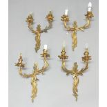 SET OF FOUR GILT METAL WALL LIGHTS, each with two scrolling foliate branches, height 43cm, width