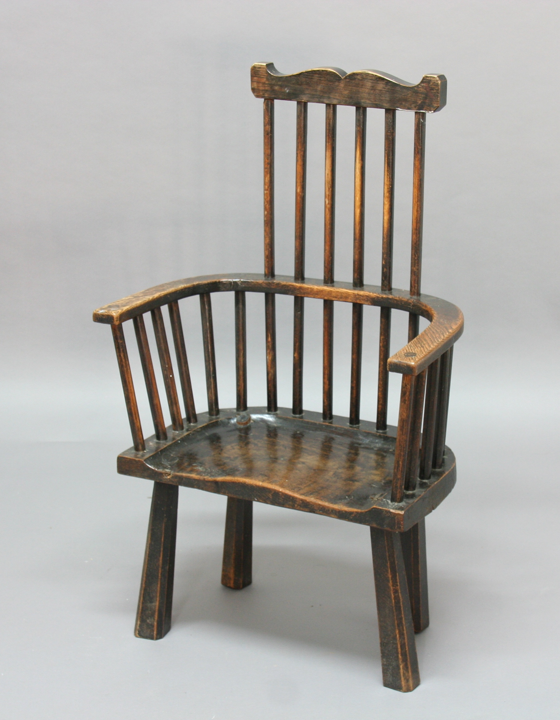 PRIMATIVE COMB BACK WINDSOR CHAIR, possibly late 18th century, ash and elm, with shaped top rail,