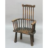 PRIMATIVE COMB BACK WINDSOR CHAIR, possibly late 18th century, ash and elm, with shaped top rail,