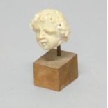 AFTER THE ANTIQUE: carved stone head of a child with curly head, height excluding base 6.5cm