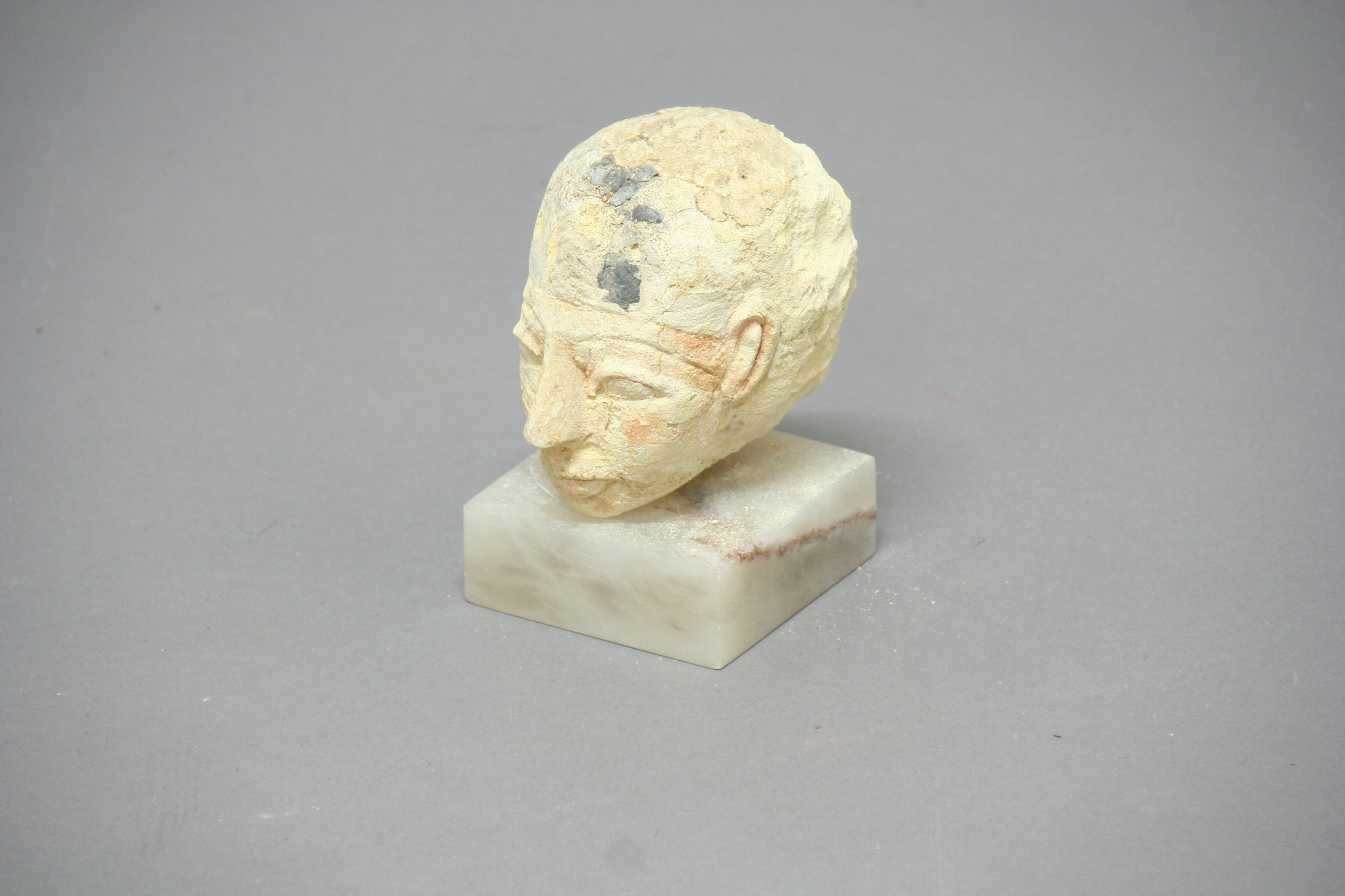 ANTIQUITIES: an Egyptian carved sandstone head, probably of a pharaoh, with traces of pigment,