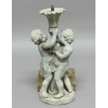 LEAD FOUNTAIN, modelled as two children holding up a flowerhead, on a stone base, height excluding