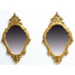 PAIR OF GEORGE III STYLE GILT GESSO WALL MIRRORS, 19th century, of cartouche shape with scrolling