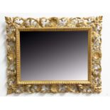 FLORENTINE STYLE WALL MIRROR, the square plate inside a gilt scrolling foliate frame centred on