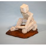 •RACHEL RECKITT (1908-1995) SEATED FIGURE Cast concrete blocks upon a wooden base 37cm high ++