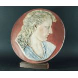 GEORGE BLACKALL SIMONDS Circular Stoneware Plaque with a bust of a Preraphaelite style classical