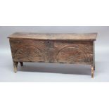 OAK SIX PLANK COFFER, late 17th or early 18th century, with vacant interior and carved decoration
