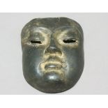BRONZE DEATH MASK, with two pierced eye slots, height 17cm