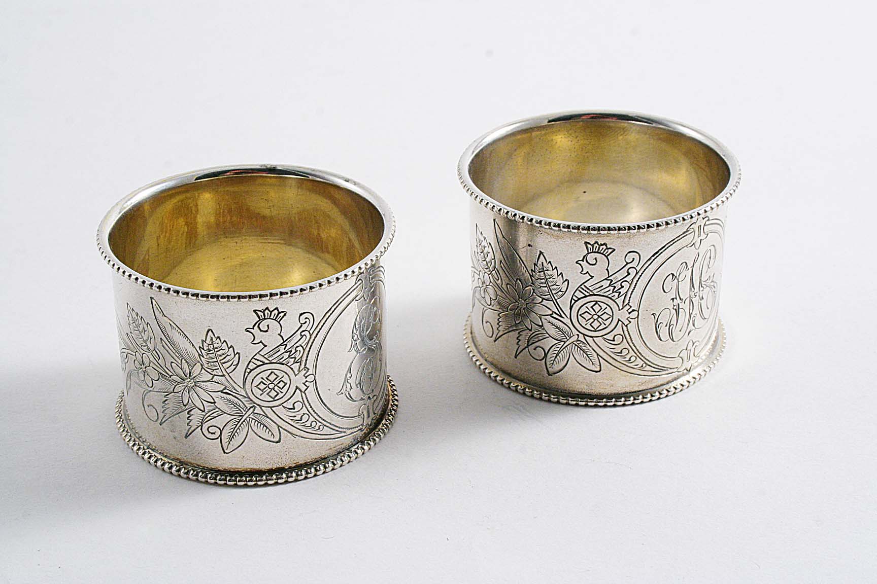 FABERGE:- A pair of late 19th century Russian engraved napkin rings, one initialled "ES", the
