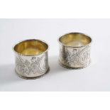 FABERGE:- A pair of late 19th century Russian engraved napkin rings, one initialled "ES", the