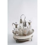 A GEORGE III BOAT-SHAPED EIGHT BOTTLE CRUET FRAME fitted with two mounted and four non-mounted,