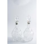 A PAIR OF MOUNTED CUT-GLASS MALLET-SHAPED DECANTERS & STOPPERS with fruiting vines around the middle