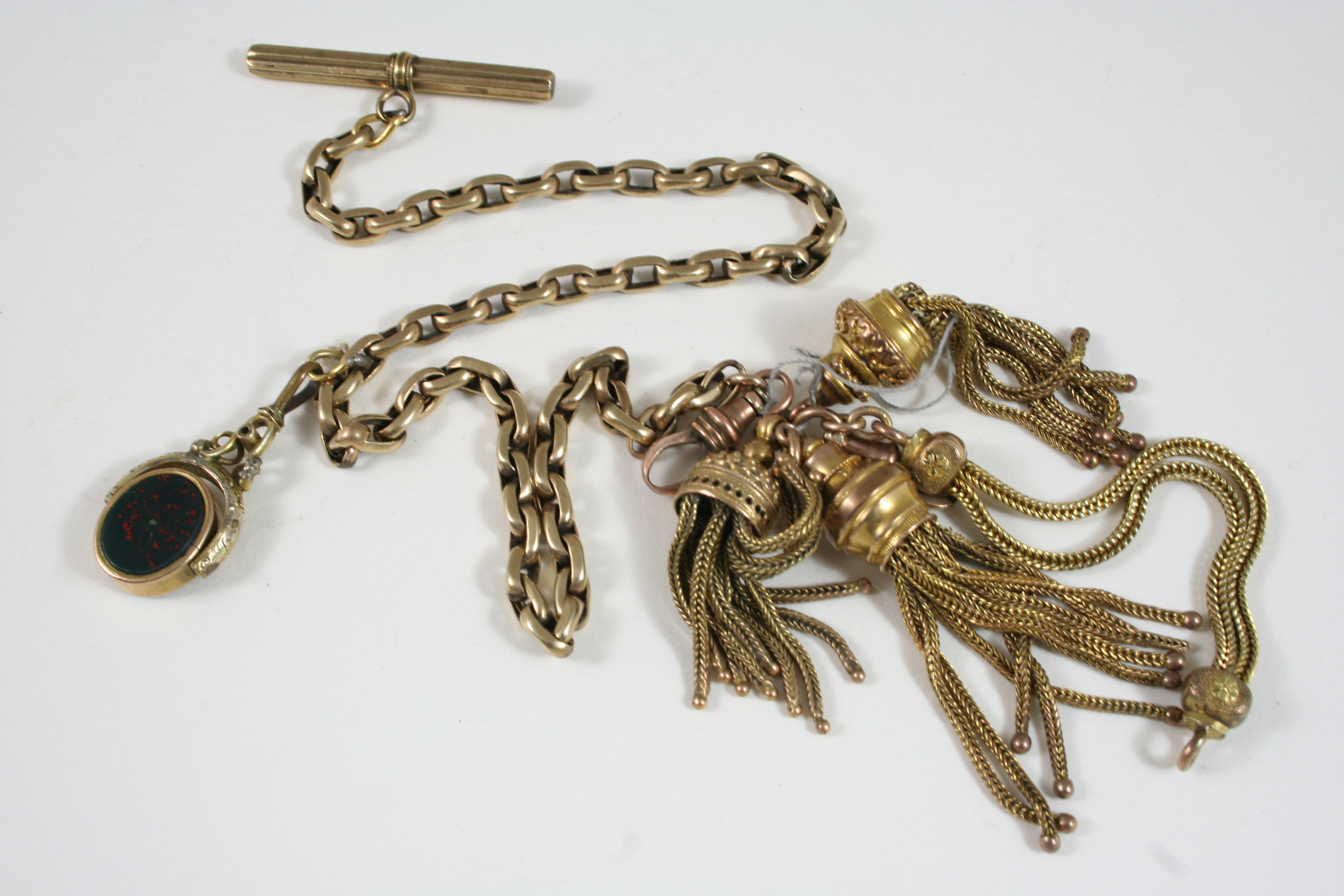 A GOLD WATCH CHAIN with spinning fob and tassels, 29.5cm. long, total weight 35 grams.