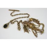 A GOLD WATCH CHAIN with spinning fob and tassels, 29.5cm. long, total weight 35 grams.