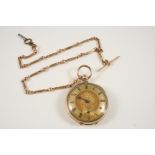 A GOLD OPEN FACED POCKET WATCH the gold foliate dial with Roman numerals and subsidiary seconds