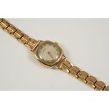 A LADY'S 9CT. GOLD WRISTWATCH BY VERTEX the signed circular dial with Roman numerals, on an 18ct.