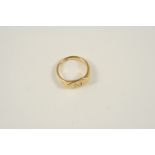 AN 18CT. GOLD SIGNET RING engraved with the initial M, 6.2 grams. Size L.