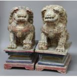 PAIR OF CHINESE CARVED AND PAINTED WOOD DOGS OF FO, modelled seats with a front paw resting on a
