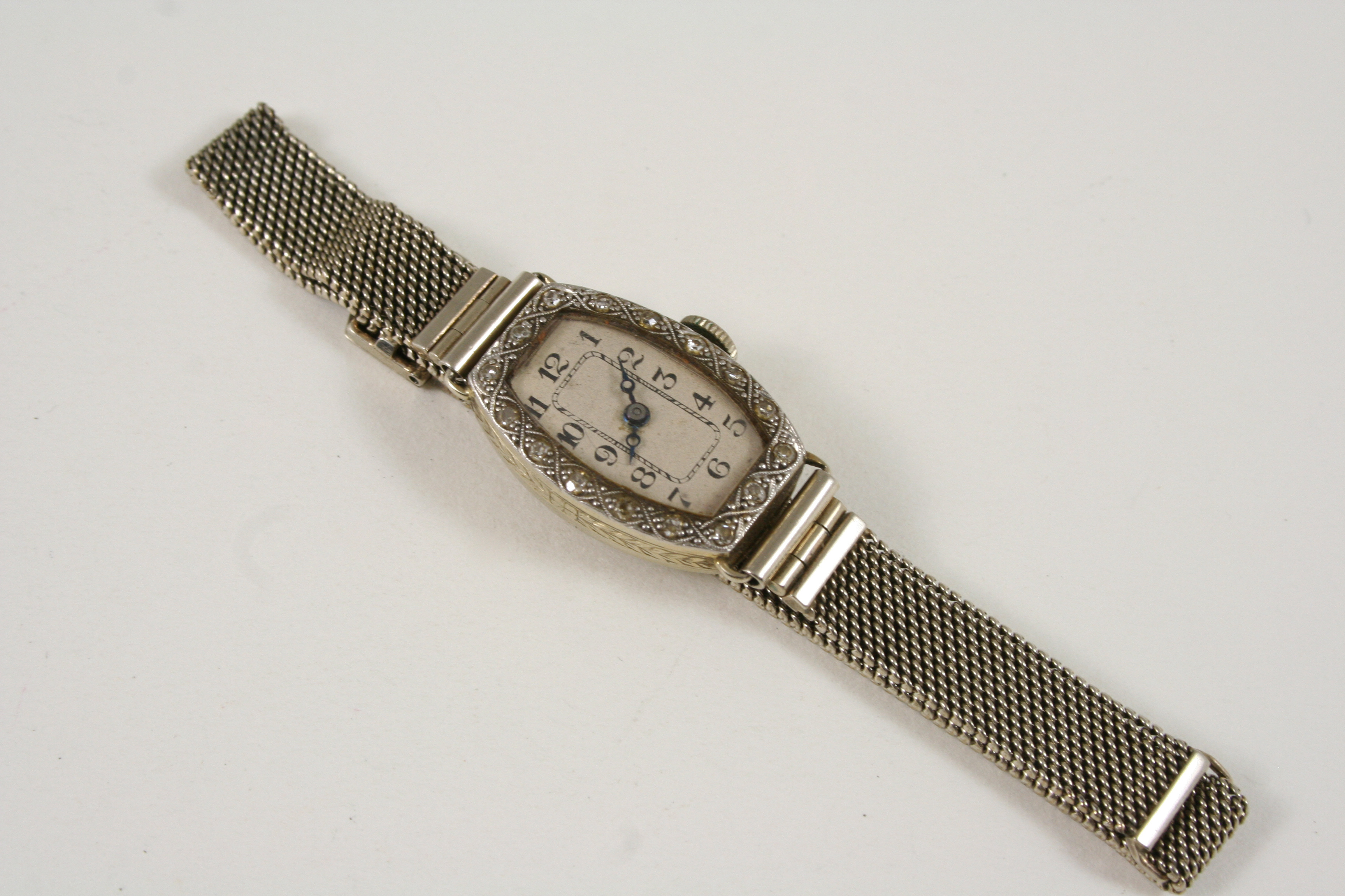 A LADY'S 18CT. GOLD DIAMOND COCKTAIL WRISTWATCH the tonneau-shaped dial with Arabic numerals and